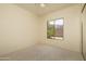 Neutral bedroom with a large window and a mirrored closet at 6917 E Night Glow Cir, Scottsdale, AZ 85266