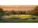 Beautiful sunset view of golfers enjoying a round on community golf course at 6917 E Night Glow Cir, Scottsdale, AZ 85266