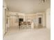 Inviting kitchen featuring tile floors, light-colored cabinets, a breakfast bar, and open access to other living areas at 6917 E Night Glow Cir, Scottsdale, AZ 85266