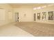 Bright living room featuring carpet and tile floors, tray ceilings, and large windows at 6917 E Night Glow Cir, Scottsdale, AZ 85266