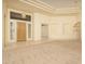 Open-concept living area boasting tile and carpet floors, tray ceilings, and a grand front door at 6917 E Night Glow Cir, Scottsdale, AZ 85266