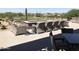 Outdoor patio featuring comfortable wicker seating and a fire pit with picturesque golf course views at 6917 E Night Glow Cir, Scottsdale, AZ 85266