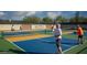 Pickleball courts with players, a desert landscape, and sunny skies at 6917 E Night Glow Cir, Scottsdale, AZ 85266