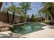 Landscaped backyard with freeform pool and mature trees at 6917 E Night Glow Cir, Scottsdale, AZ 85266
