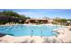 Community swimming pool featuring lap lanes, lounge chairs, and desert landscaping at 6917 E Night Glow Cir, Scottsdale, AZ 85266