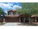 Two-story home featuring a tile roof, front porch, landscaped front yard, and an attached two-car garage at 7224 W Pioneer St, Phoenix, AZ 85043