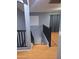 Upstairs landing showing the wood flooring, gray walls, and black railings leading to the downstairs area at 7224 W Pioneer St, Phoenix, AZ 85043