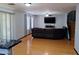 Open concept living room with laminate wood flooring with a large sectional couch and a staircase at 7224 W Pioneer St, Phoenix, AZ 85043
