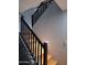 A stairway features black iron railings contrasting with the light wood stairs at 7224 W Pioneer St, Phoenix, AZ 85043