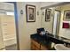 Bathroom features tile floors, a dark granite countertop, and a shower-tub combo at 7940 W Avalon Dr, Phoenix, AZ 85033