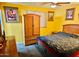 Traditional style bedroom featuring carpeted floors, a ceiling fan and bright yellow walls at 7940 W Avalon Dr, Phoenix, AZ 85033