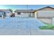 Home featuring a large driveway, small lawn, and front entrance at 7940 W Avalon Dr, Phoenix, AZ 85033