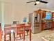 Dining area adjacent to kitchen with stainless steel refrigerator and wood cabinets at 7940 W Avalon Dr, Phoenix, AZ 85033