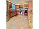 Updated kitchen features wood cabinets, stainless steel appliances, and tile flooring at 7940 W Avalon Dr, Phoenix, AZ 85033