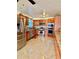 Spacious kitchen featuring tile floors, wood cabinets, and modern stainless steel appliances at 7940 W Avalon Dr, Phoenix, AZ 85033