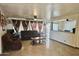Inviting living room featuring tile floors, open layout, and backyard access at 7940 W Avalon Dr, Phoenix, AZ 85033