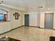 Bright living room with tile flooring, neutral walls, and gray doors at 7940 W Avalon Dr, Phoenix, AZ 85033