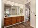 Bright bathroom with wood vanity, large mirror, and an adjacent toilet room with decorative towels at 839 S Westwood -- # 287, Mesa, AZ 85210