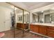 Spacious bathroom featuring dual sinks, wood cabinets, ample counter space, and large mirrors at 839 S Westwood -- # 287, Mesa, AZ 85210