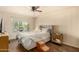 Comfortable bedroom featuring wood floors, a ceiling fan, and a large window for natural light at 839 S Westwood -- # 287, Mesa, AZ 85210