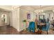 Dining area with wood floors, view of the mirrored wall, and a table with blue upholstered chairs at 839 S Westwood -- # 287, Mesa, AZ 85210