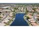 Breathtaking aerial view of a waterfront community, showcasing stunning homes, lush landscaping, and a tranquil lake at 869 W Shellfish Dr, Gilbert, AZ 85233