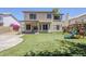 Spacious backyard with artificial turf, covered patio, swing set and room for outdoor activities at 869 W Shellfish Dr, Gilbert, AZ 85233
