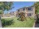 This backyard boasts a pristine lawn, a play structure, and a covered patio, making it perfect for families at 869 W Shellfish Dr, Gilbert, AZ 85233