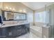 Bathroom with a double sink vanity, soaking tub, and tiled floors at 869 W Shellfish Dr, Gilbert, AZ 85233