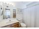 Bathroom with a wood vanity, large mirror, and shower with tub at 869 W Shellfish Dr, Gilbert, AZ 85233