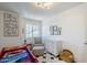 Bright bedroom featuring a soft gray chair and a decorative gallery wall at 869 W Shellfish Dr, Gilbert, AZ 85233