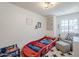 Whimsical bedroom with a race car bed, soft gray chair, and playful decor at 869 W Shellfish Dr, Gilbert, AZ 85233