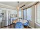 Bright dining area featuring a round table, blue velvet chairs, and a stainless steel refrigerator at 869 W Shellfish Dr, Gilbert, AZ 85233