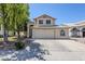 Inviting two-story home featuring a neutral color palette, large windows, and a well-maintained front yard at 869 W Shellfish Dr, Gilbert, AZ 85233