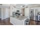 Bright kitchen featuring a stone countertop island, stainless steel appliances, and white cabinets at 869 W Shellfish Dr, Gilbert, AZ 85233