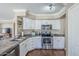 Bright kitchen featuring stainless steel appliances, a stone countertop island, and white cabinets at 869 W Shellfish Dr, Gilbert, AZ 85233
