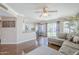 Open-concept living room featuring a gray sectional sofa, wood floors, and seamless transition to the kitchen at 869 W Shellfish Dr, Gilbert, AZ 85233