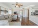 Spacious living room with a gray sofa, laminate floors, and an entryway into the kitchen at 869 W Shellfish Dr, Gilbert, AZ 85233
