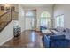 Spacious living room featuring hardwood floors, arched windows, and comfortable seating at 869 W Shellfish Dr, Gilbert, AZ 85233