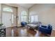 Elegant living room with arched windows, hardwood floors, and comfortable seating arrangement at 869 W Shellfish Dr, Gilbert, AZ 85233