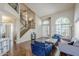 Inviting living room featuring hardwood floors, staircase, large windows, and comfortable seating at 869 W Shellfish Dr, Gilbert, AZ 85233