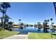 Scenic waterfront community view with palm trees and tranquil water reflecting blue sky, perfect for relaxed living at 869 W Shellfish Dr, Gilbert, AZ 85233