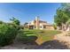 Expansive backyard with manicured landscaping and a view of the two-story home at 9121 E Karen Dr, Scottsdale, AZ 85260