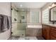 Updated bathroom featuring a glass enclosed shower, soaking tub and modern finishes at 9121 E Karen Dr, Scottsdale, AZ 85260