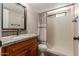 Bright bathroom featuring a vanity with granite countertop and a shower with neutral-toned curtain at 9121 E Karen Dr, Scottsdale, AZ 85260
