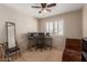 Bedroom features a dark-toned ceiling fan and large windows providing natural light for working or relaxing at 9121 E Karen Dr, Scottsdale, AZ 85260