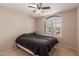 Cozy bedroom with plush carpeting, ceiling fan, and shuttered windows offering natural light at 9121 E Karen Dr, Scottsdale, AZ 85260
