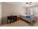 Bedroom featuring a ceiling fan, window shutters and a desk, perfect for working from home at 9121 E Karen Dr, Scottsdale, AZ 85260