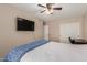 Comfortable bedroom with a ceiling fan, closet and convenient desk at 9121 E Karen Dr, Scottsdale, AZ 85260
