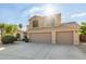 Charming two-story home featuring a spacious driveway and a low-maintenance desert landscape at 9121 E Karen Dr, Scottsdale, AZ 85260